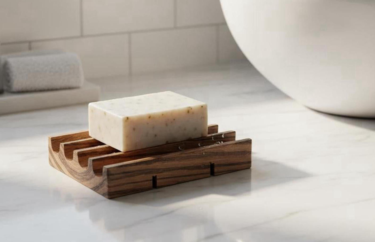 Wooden soap dish with a bar of soap to help extend the life of a bar soap.